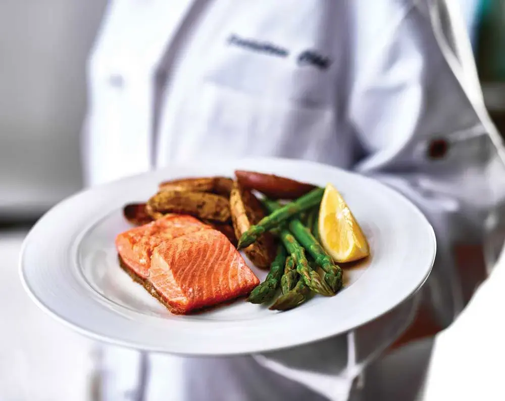 Orchard Heights Chef Created Meals, chef delivering a finished dish.